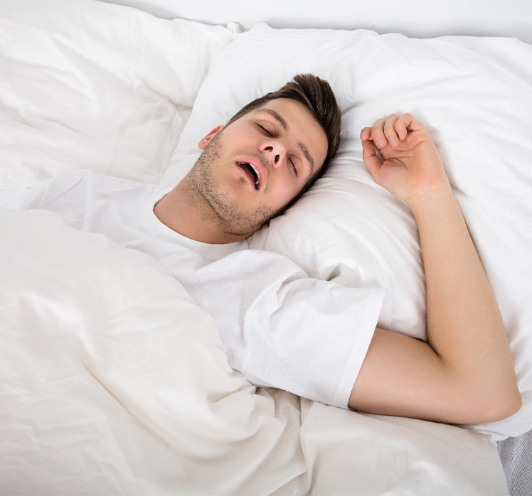 Man in white shirt with sleep apnea in Tampa snoring in bed: Close-up of a bathroom scale.
