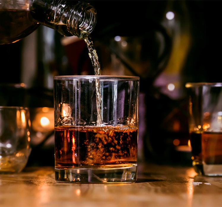 Pouring alcoholic beverage into a glass.