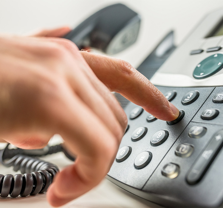 Using finger to dial a landline phone.